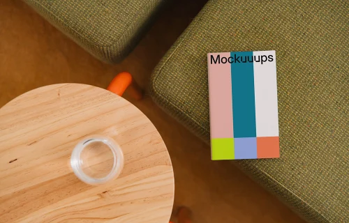 Paperback mockup on a textured sofa and wooden table