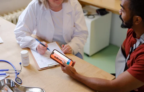 Patient holding an iPhone in doctor’s office