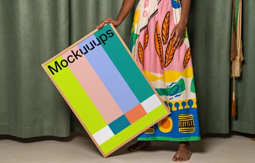 Poster mockup held against a colorful fabric backdrop