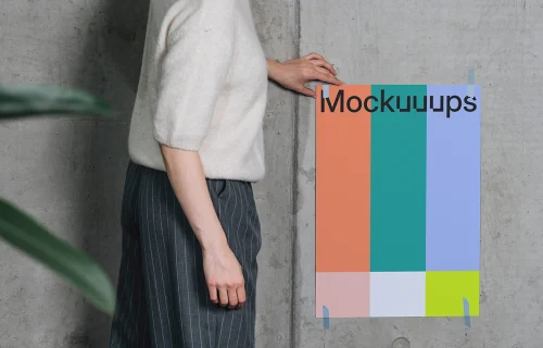 Poster mockup taped to a concrete wall with person