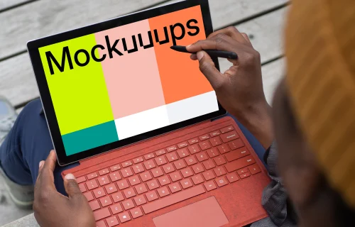 Red Microsoft Surface Laptop mockup held in a users lap