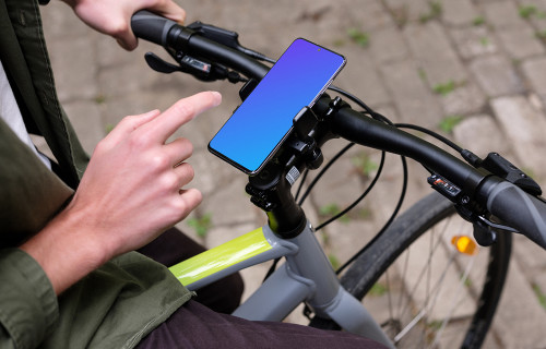 Sitting on bike tapping Samsung S20 mockup in a bike mount