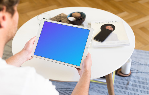 Sitting on couch and holding iPad Pro mockup