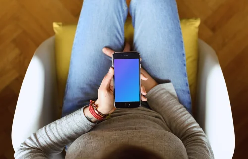 Sitting on the chair with iPhone 6s mockup