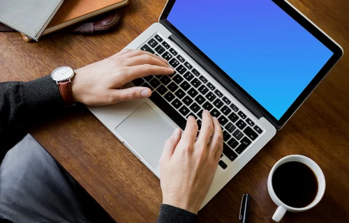 Sitting with coffee and working on Macbook Pro mockup