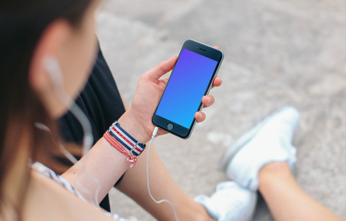 Sitting with iPhone 6 mockup and Headphones