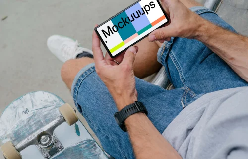 Skateboarder holding a phone mockup