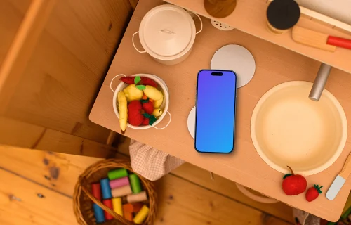 Smartphone mockup on a kid's creative table