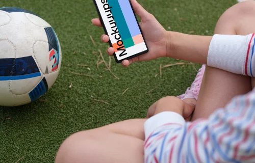 Soccer player checking on the Google Pixel 6 mockup