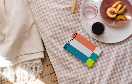 Softcover book mockup on a cozy fabric surface
