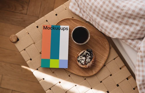 Softcover book mockup on a wooden tray with coffee and pastry