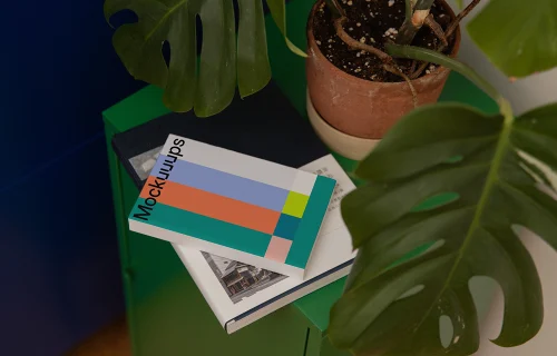 Softcover mockup on a green cabinet with plant