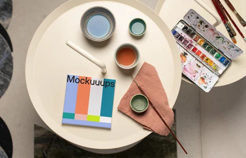 Square poster mockup with colorful palette and brushes