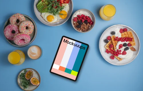 Tablet mockup around delicious breakfast meals