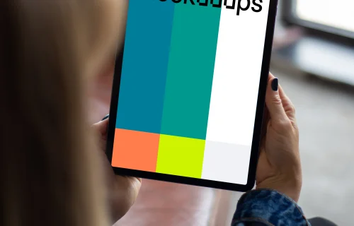 Tablet mockup held by user beside a window