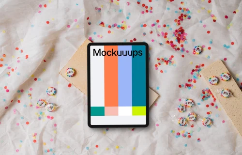 Tablet mockup on a white fabric with confetti and candy