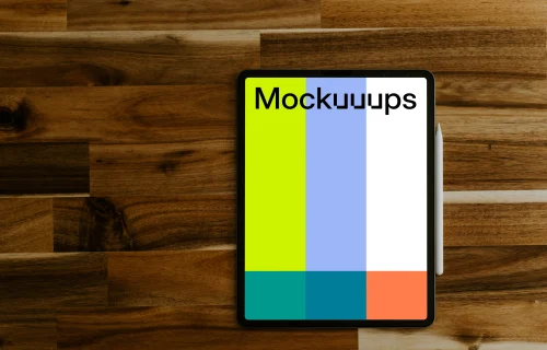 Tablet mockup on a wooden table with Apple pencil