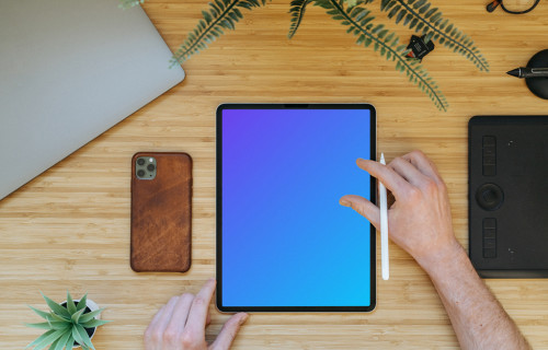 Tablet mockup on a wooden table with iPhone 11 at the side
