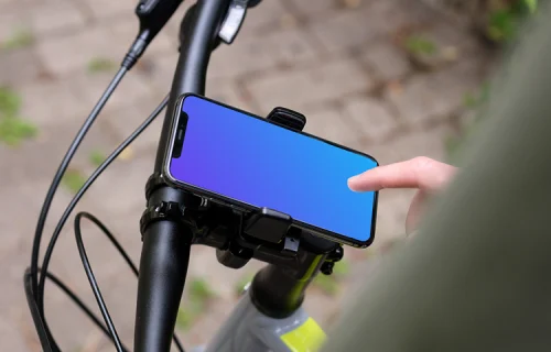Tapping on iPhone 11 Pro mockup in bike mount with handlebars to the side