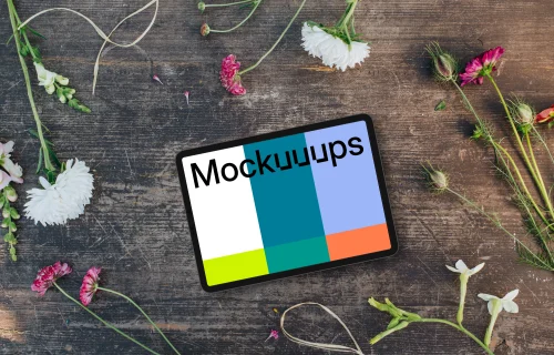 Top view of landscape tablet mockup next to flowers