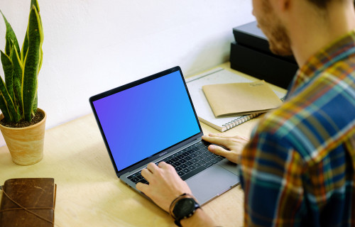 Typing on Macbook Pro mockup on desk