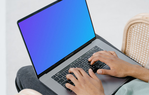 User typing on a MacBook mockup