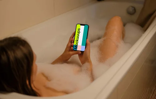 User's hands holding an iPhone 13 mockup