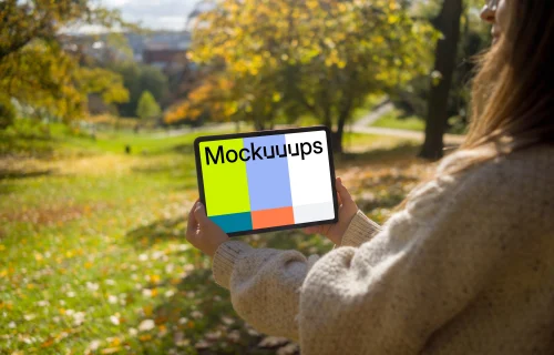 Woman holding a tablet in the garden mockup