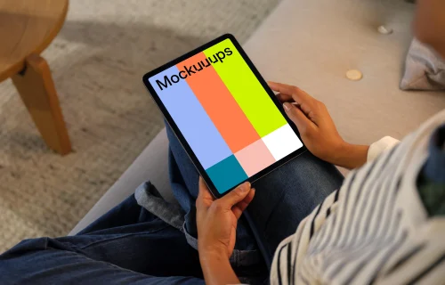 Woman holding an iPad Air mockup in cozy place