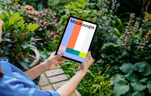 Woman holding an iPad Air mockup in garden 
