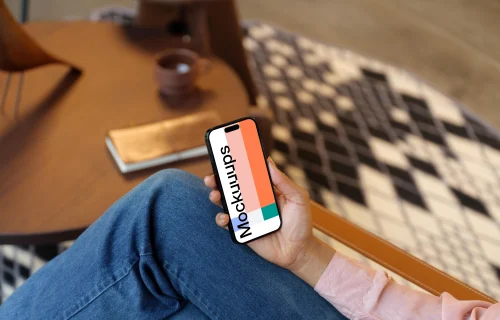 Woman holding an iPhone mockup