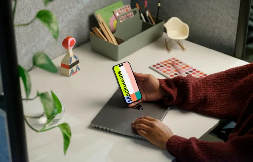 Free mockup of woman holding iPhone 14 Pro