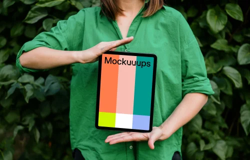 Woman showing off an iPad Air mockup in garden theme