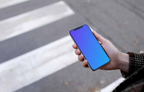Woman walking down the street with iPhone X mockup