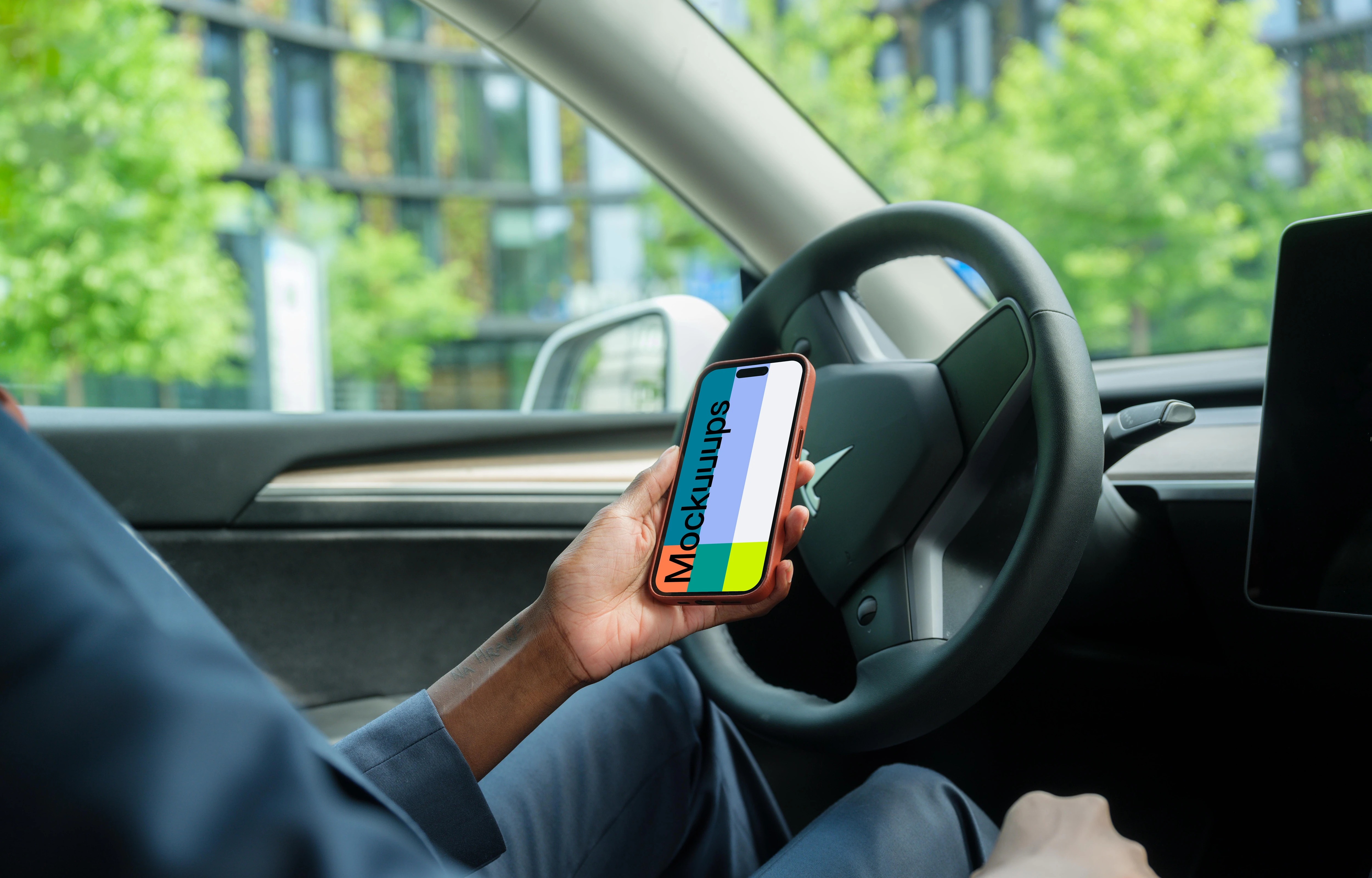 Businesswoman thriving in Tesla with iPhone 14 Pro
