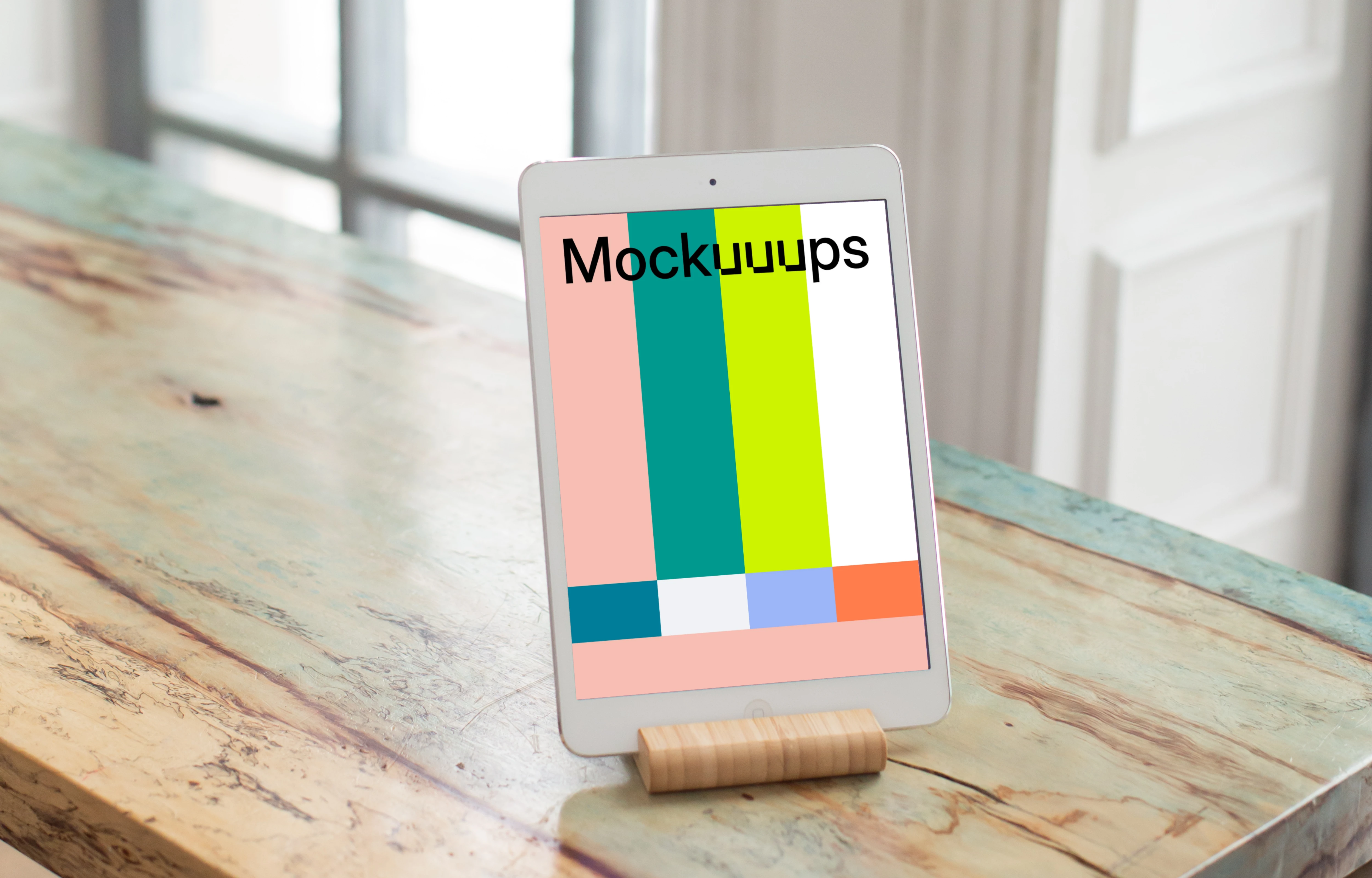 iPad Mini mockup on brightly colored wooden table