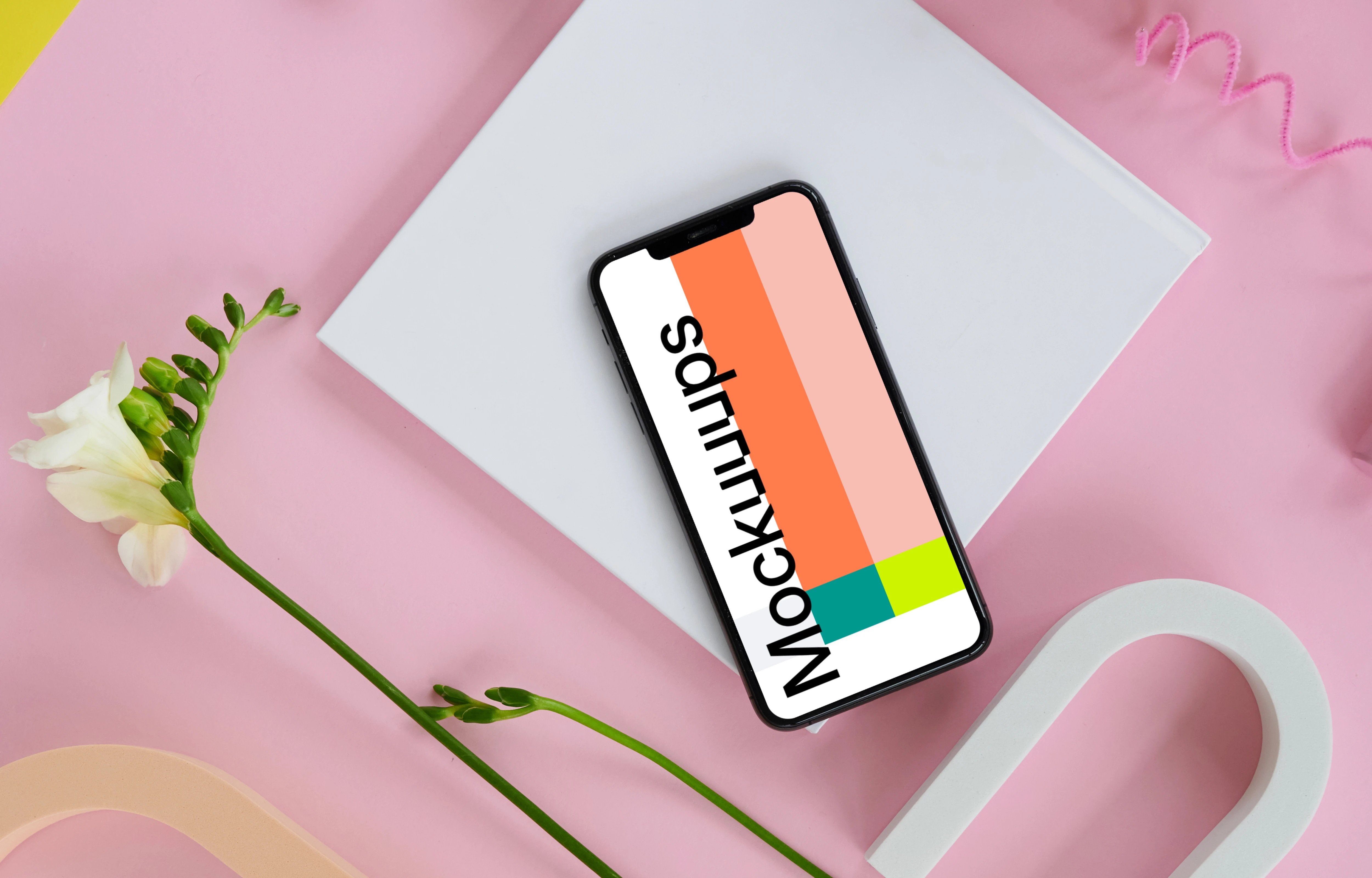 iPhone 11 mockup on a pink table