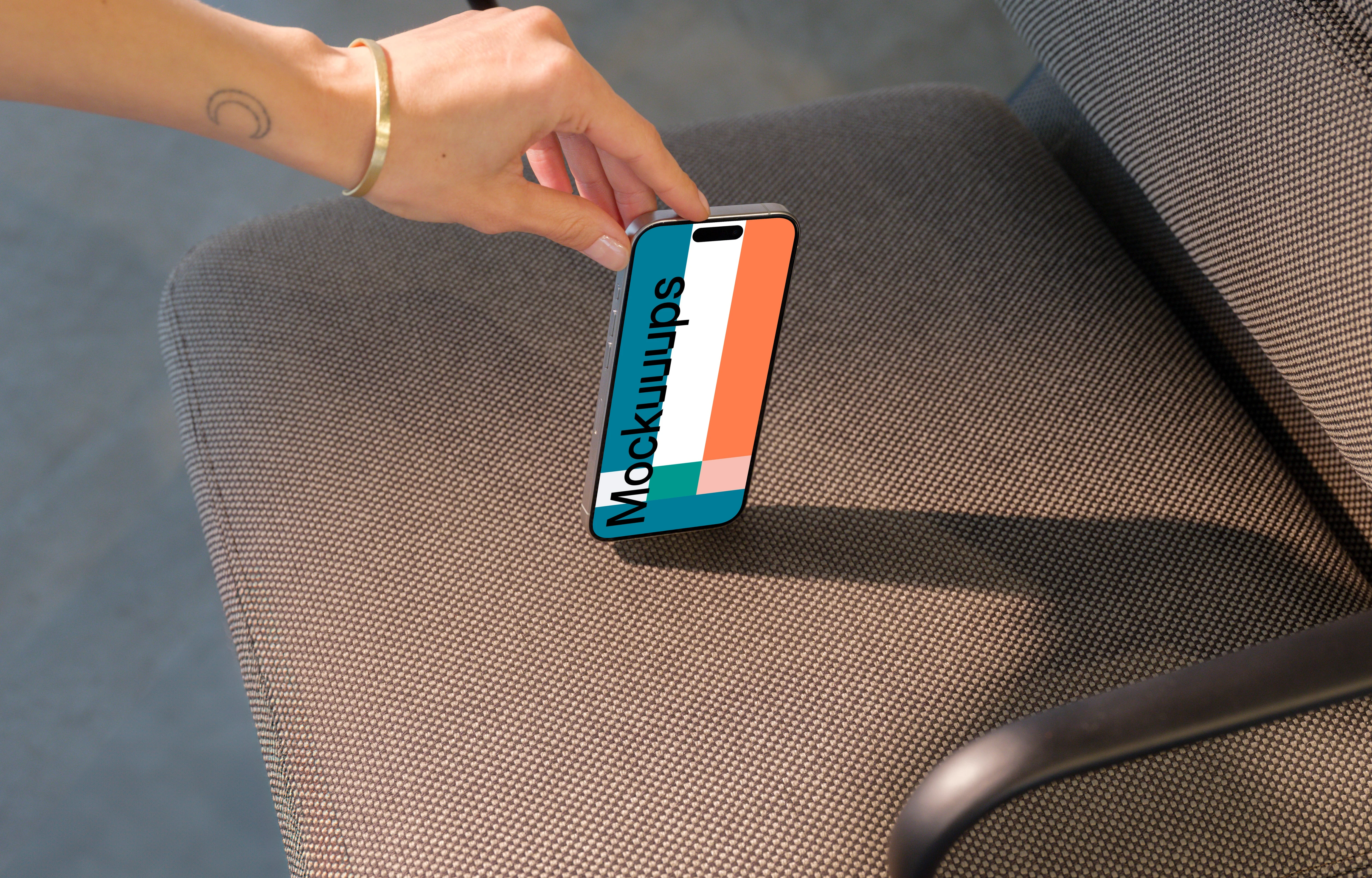 iPhone 15 Pro mockup in a modern office chair