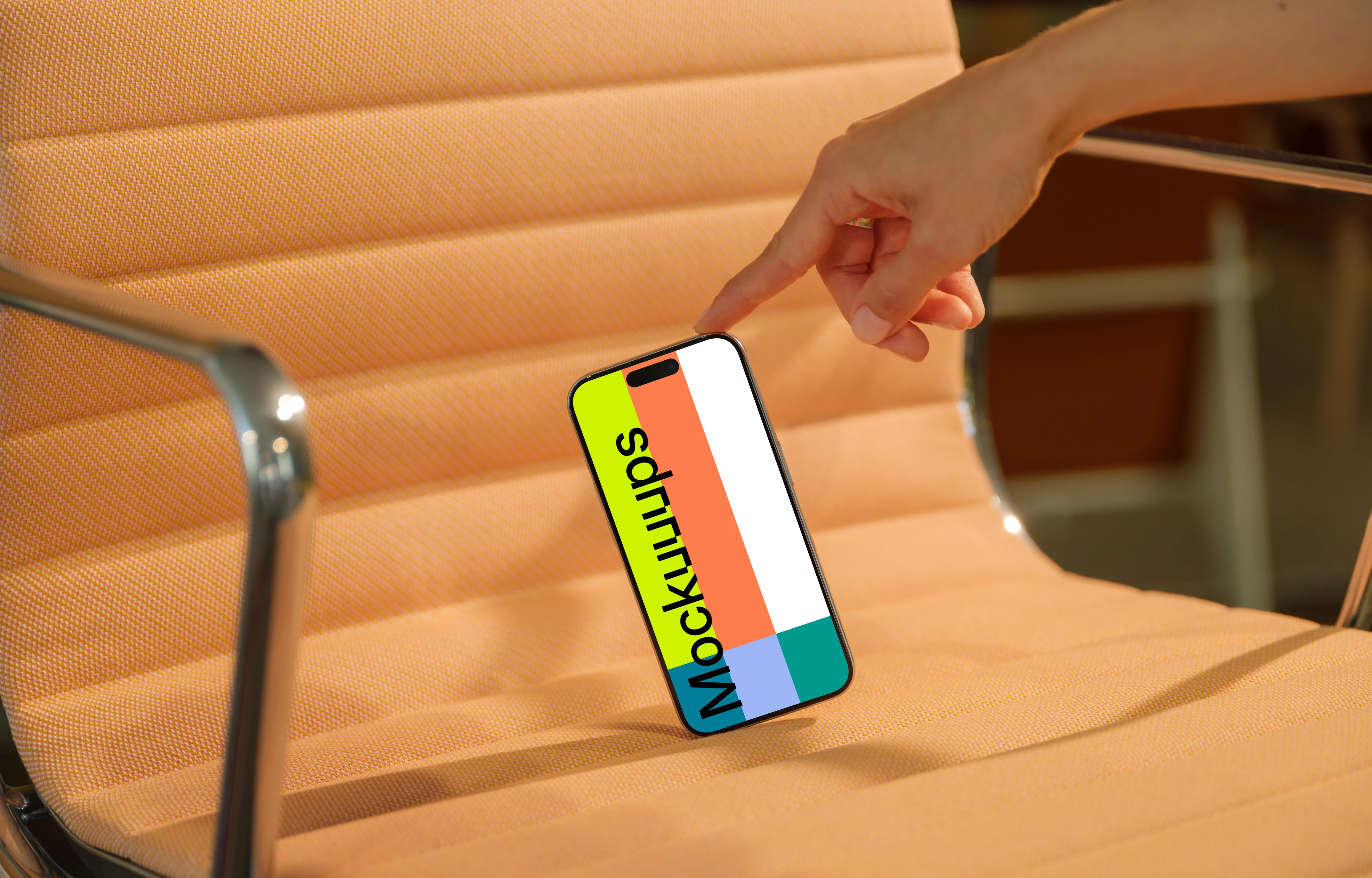 iPhone 15 Pro mockup on modern peach chair