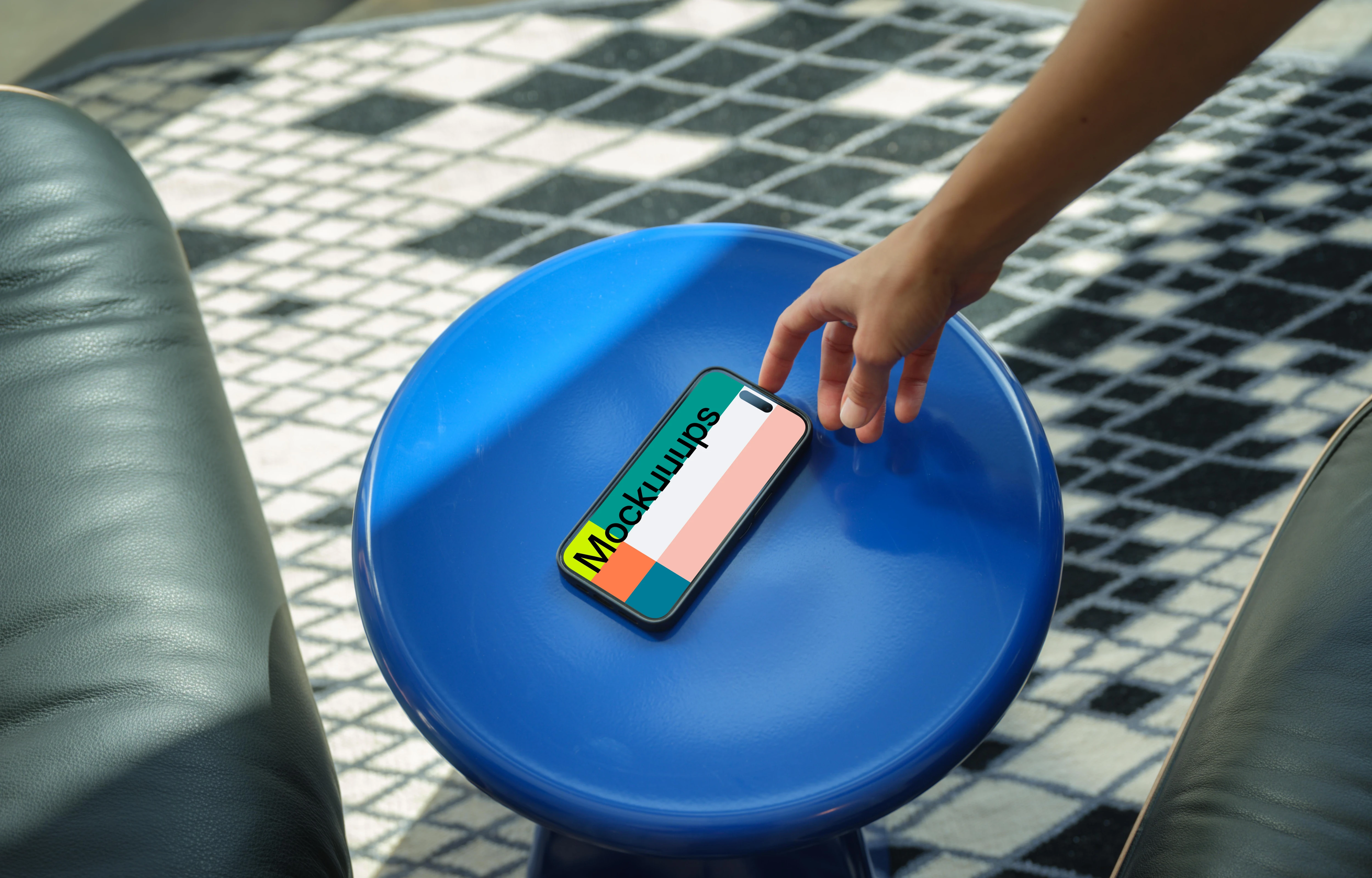 iPhone 15 Pro mockup with female hand on a blue stool