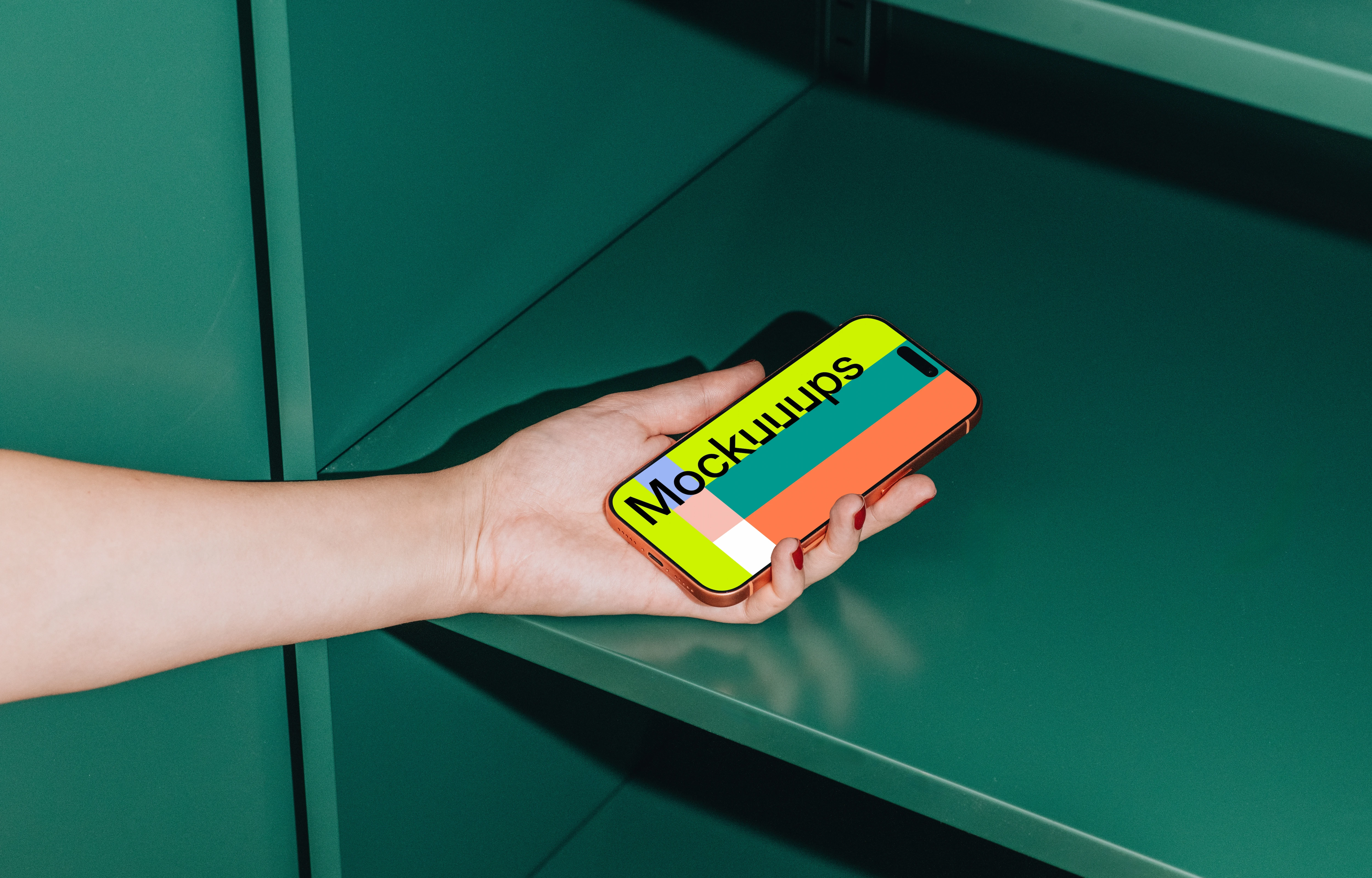 iPhone 17 Pro mockup held in a hand against a green shelf