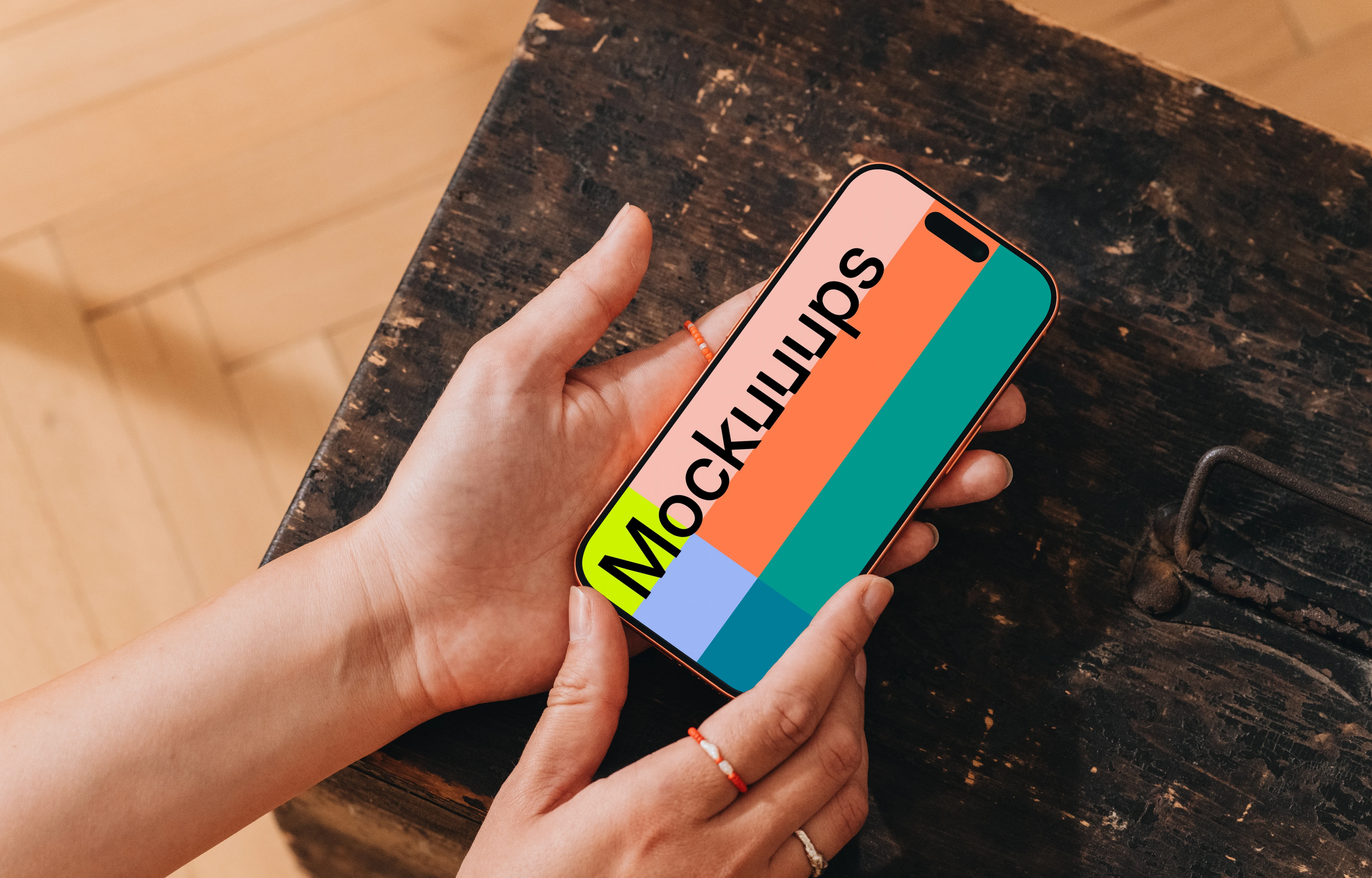 iPhone 17 Pro mockup held over a rustic table