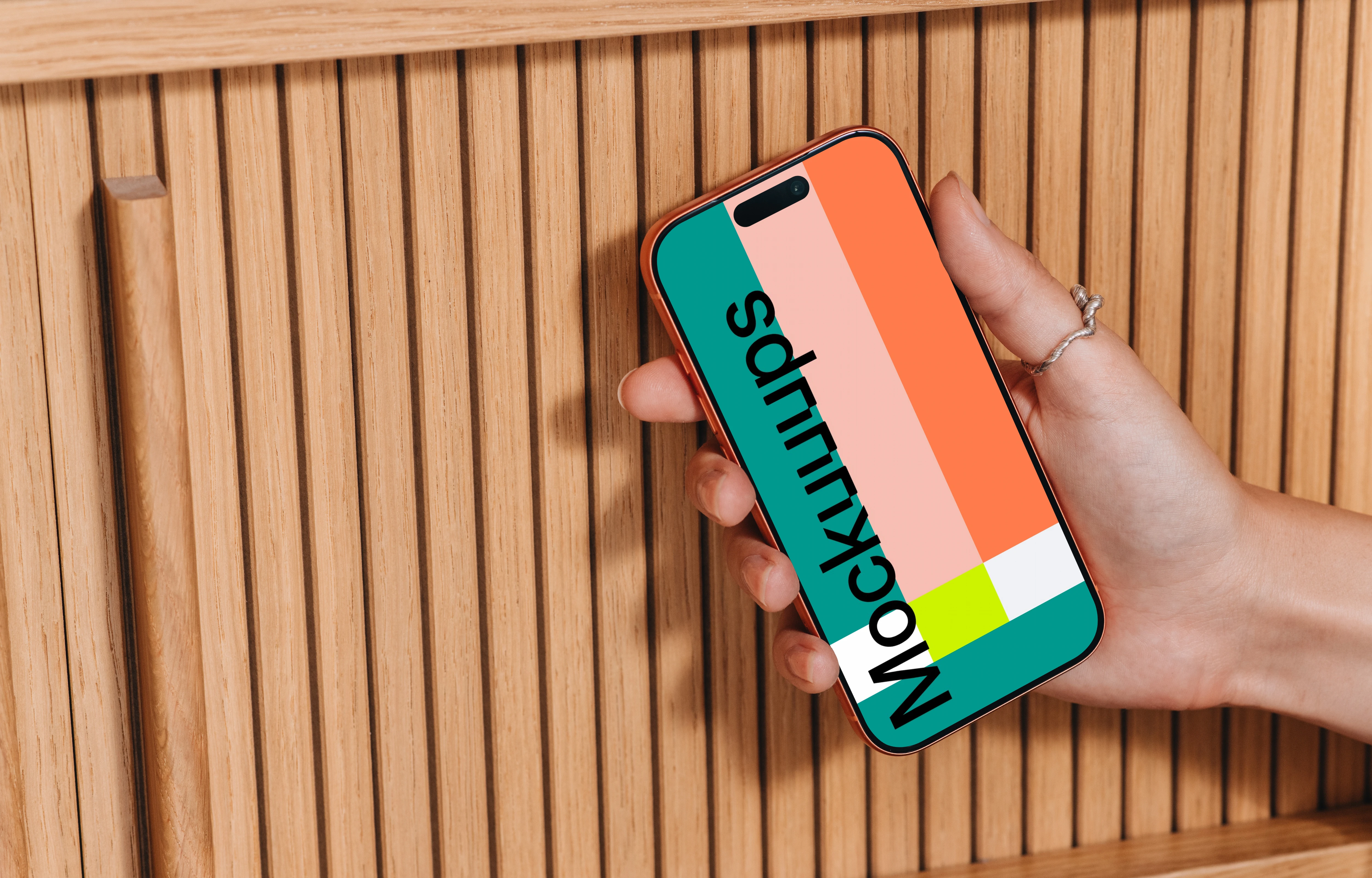 iPhone 17 Pro mockup in a hand near wooden texture