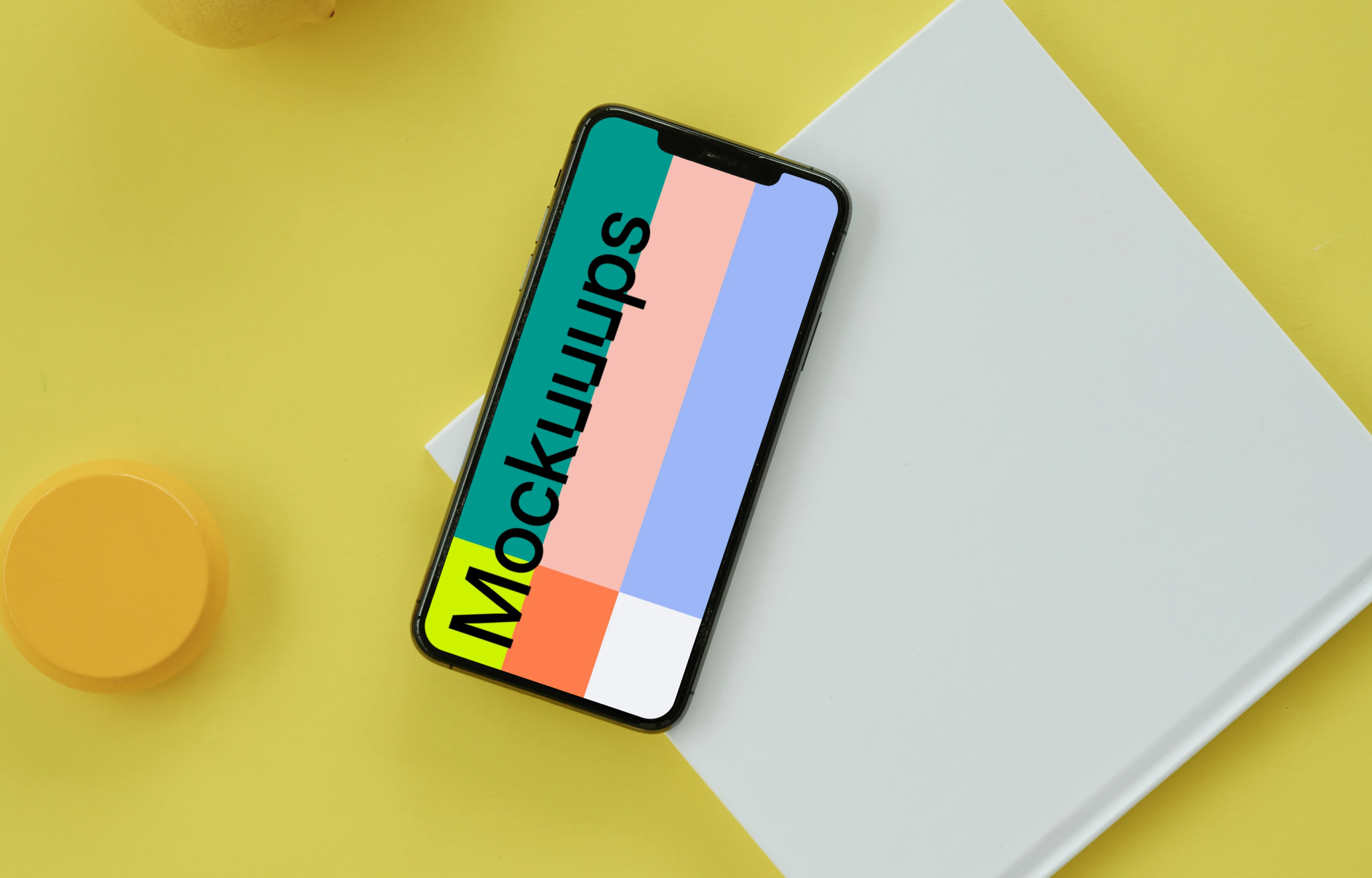 iPhone mockup on a yellow table