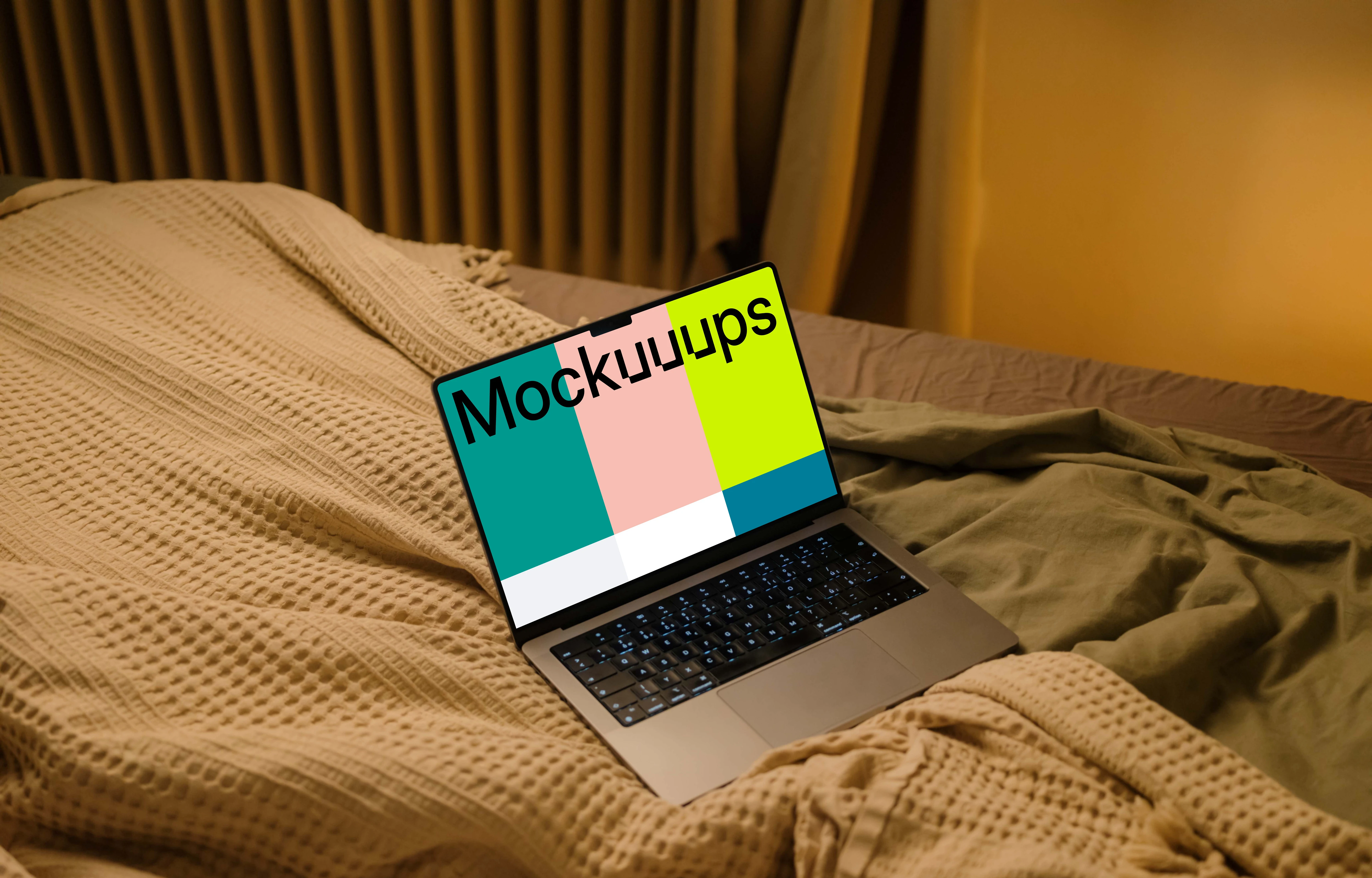 MacBook mockup on bed sheets