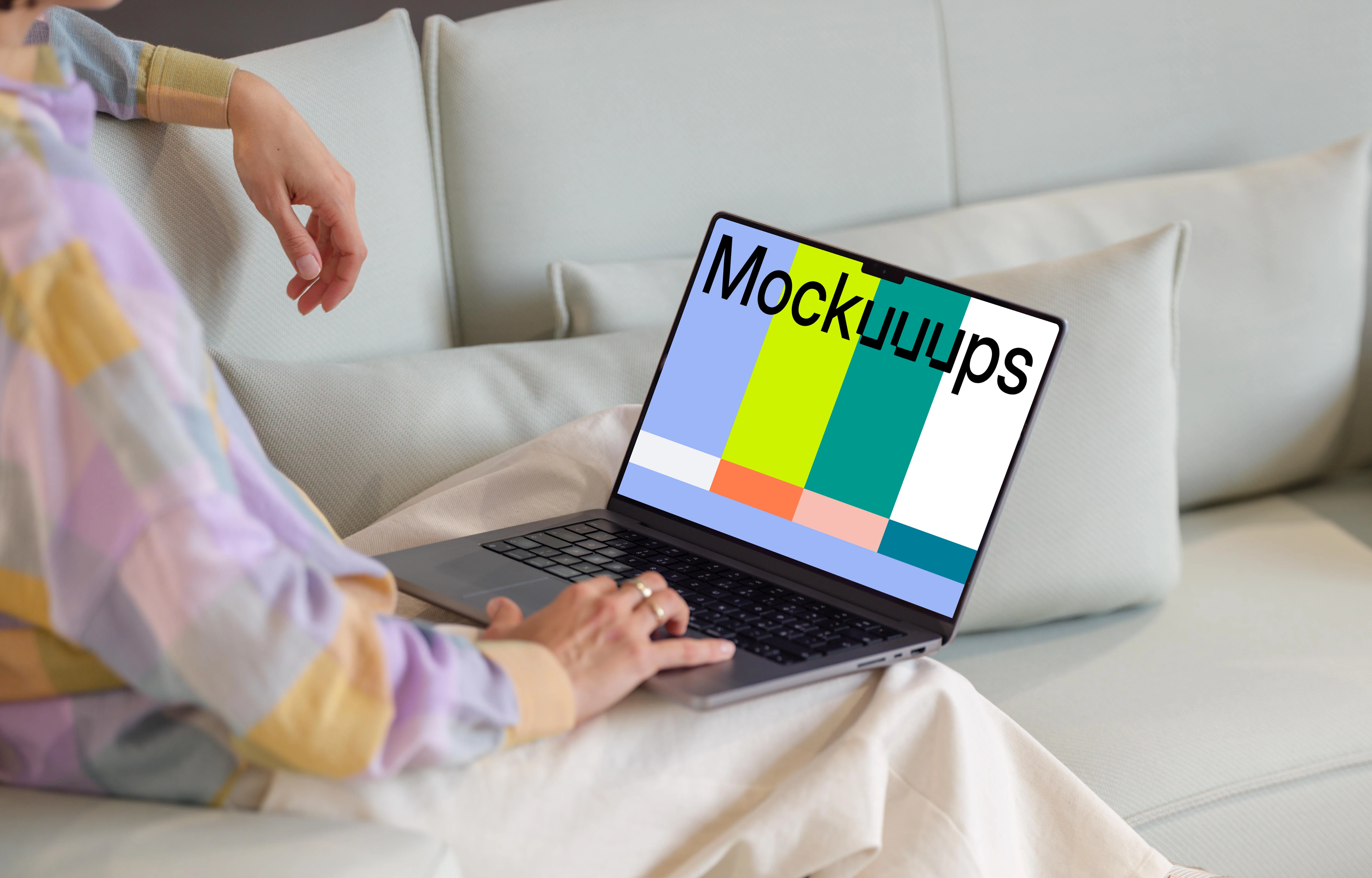 MacBook Pro mockup with woman on a modern sofa