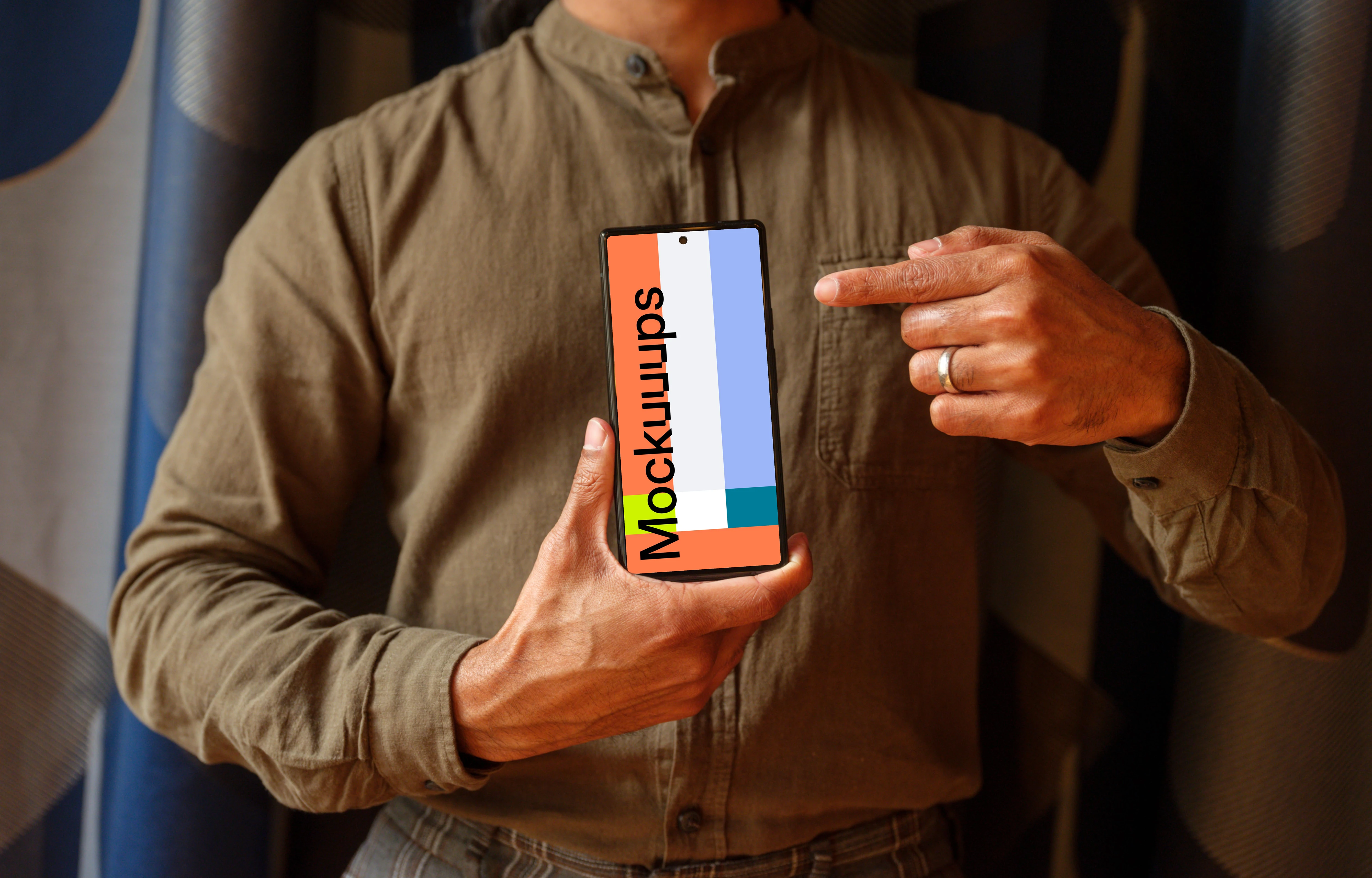Man in khaki shirt holding a Google Pixel 6 mockup