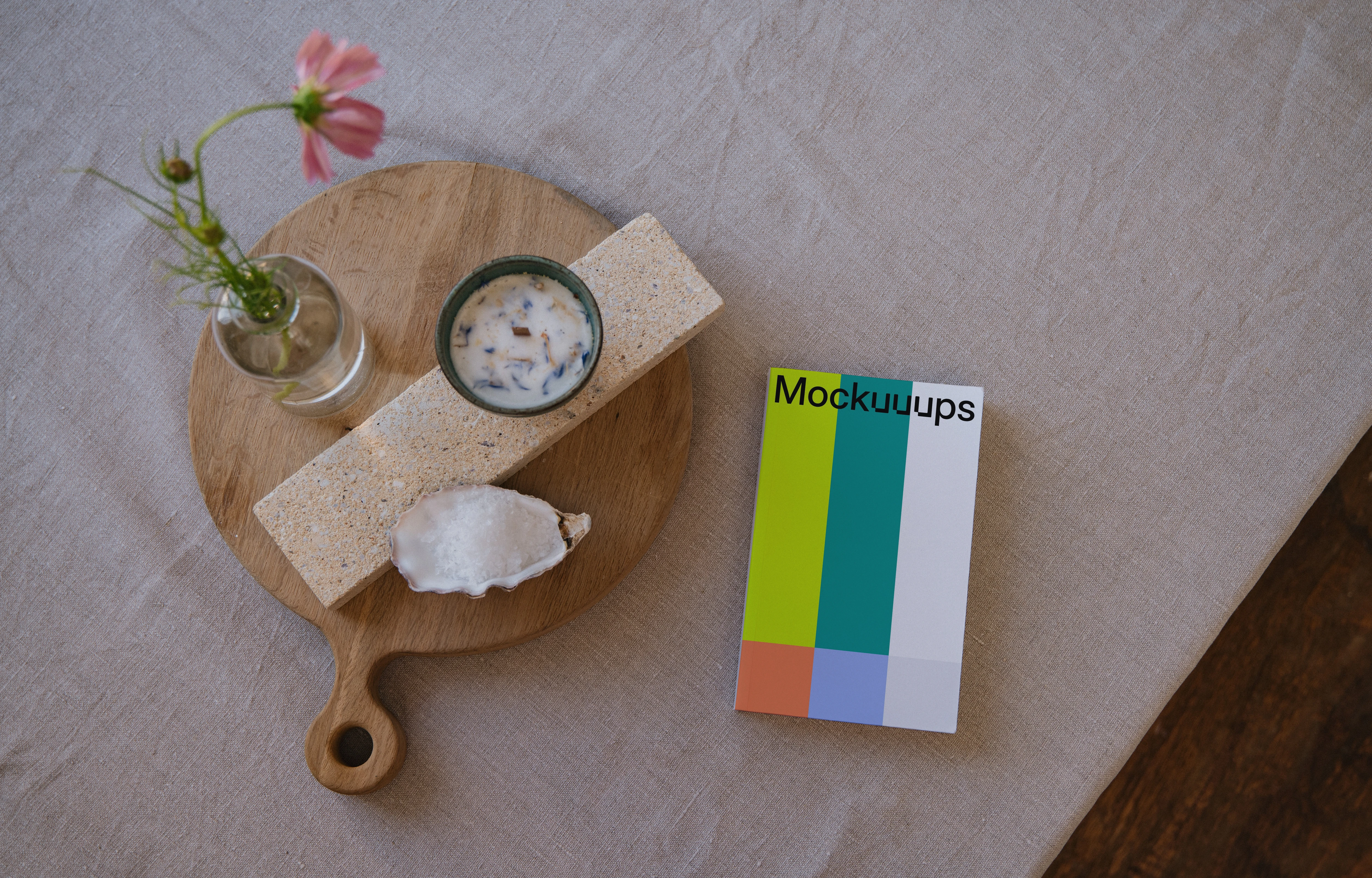 Softcover book mockup on a wooden tray with decor items