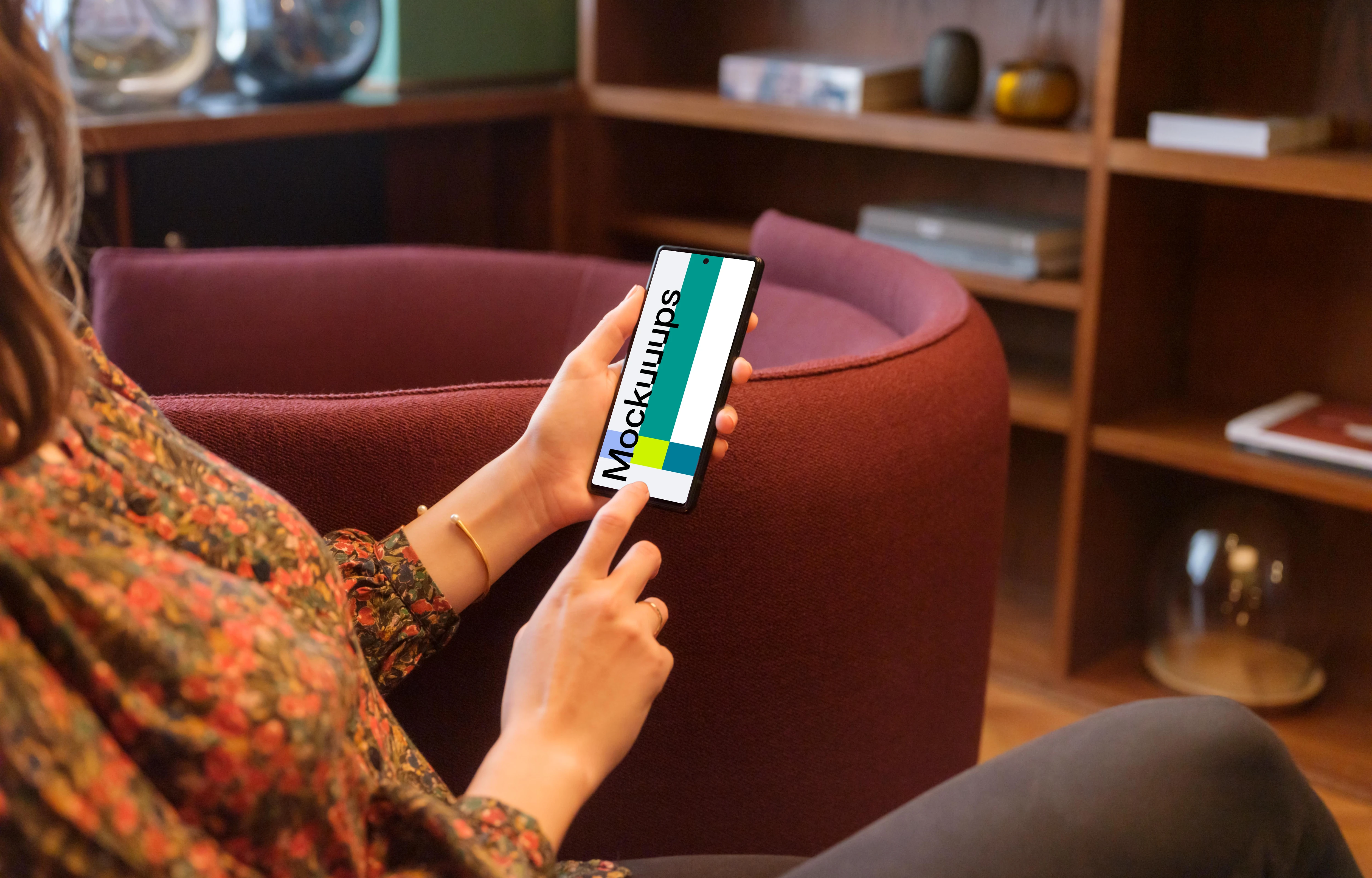 Female working on a Google Pixel mockup in a lounge area