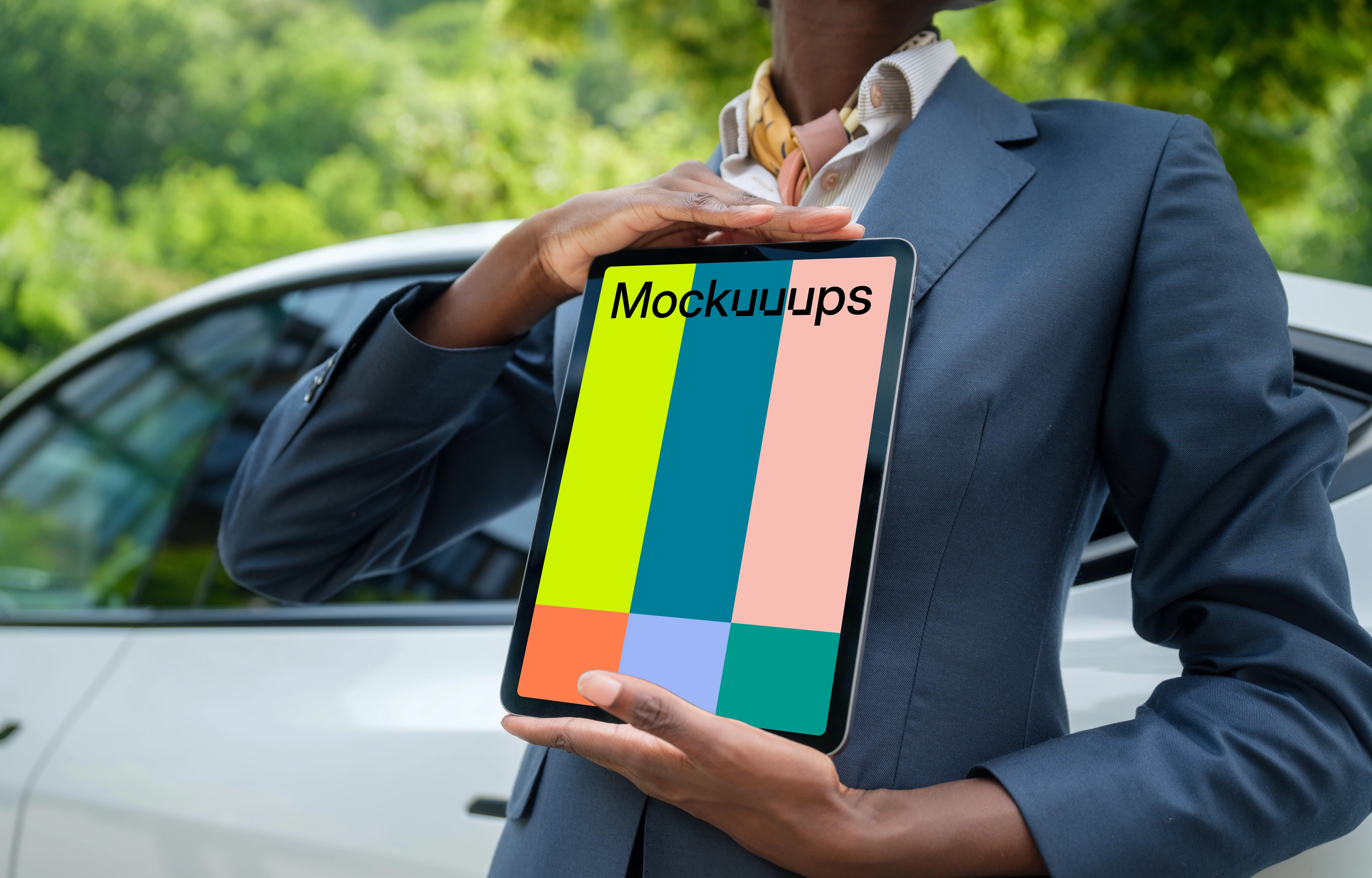 Businesswoman with iPad Mockups standing next to the Tesla
